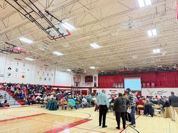 Full gym view of residents gathered to hear about consolidation and dissolution laws.